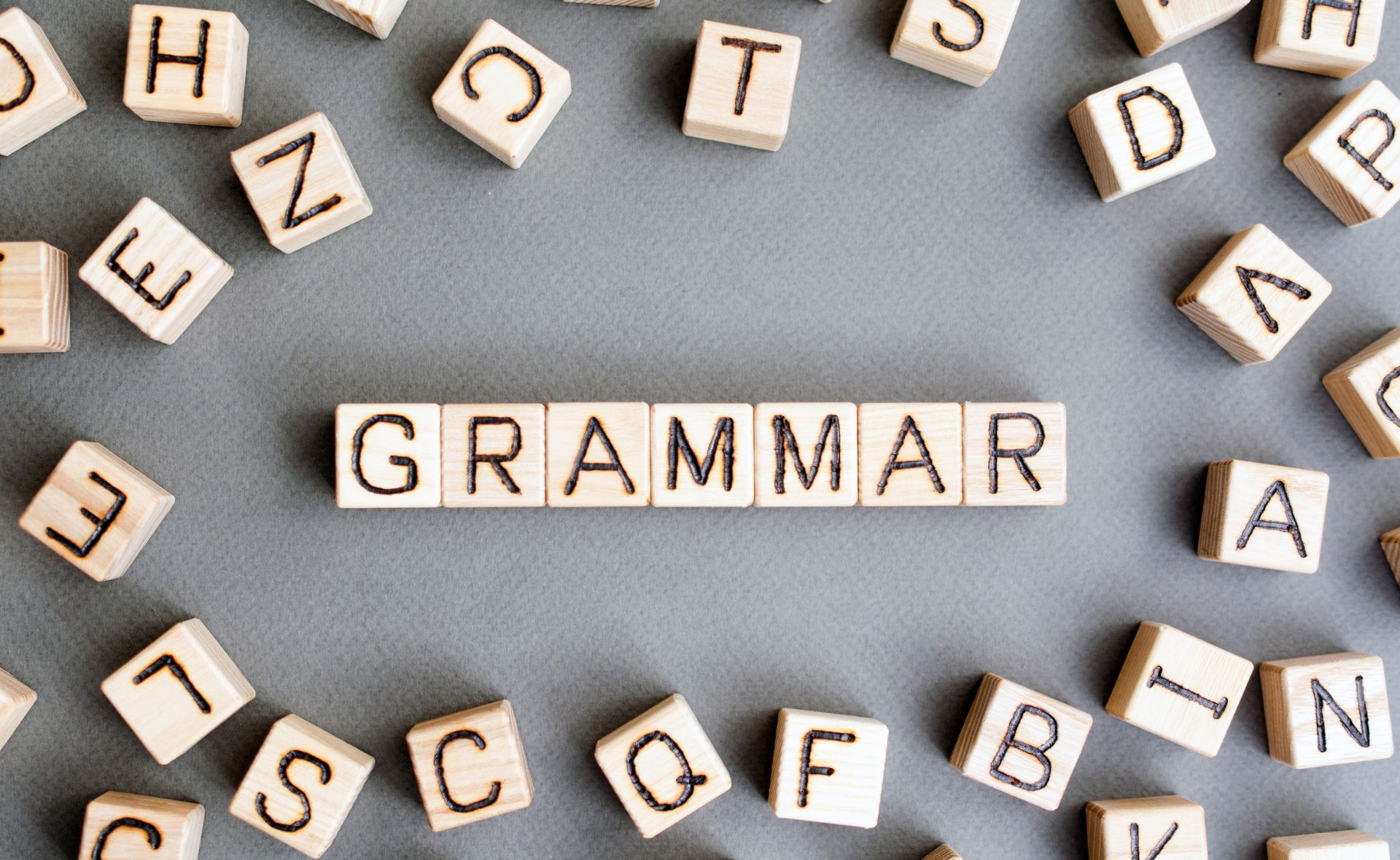 Scrabble letters forming the word Grammar | English tutor online